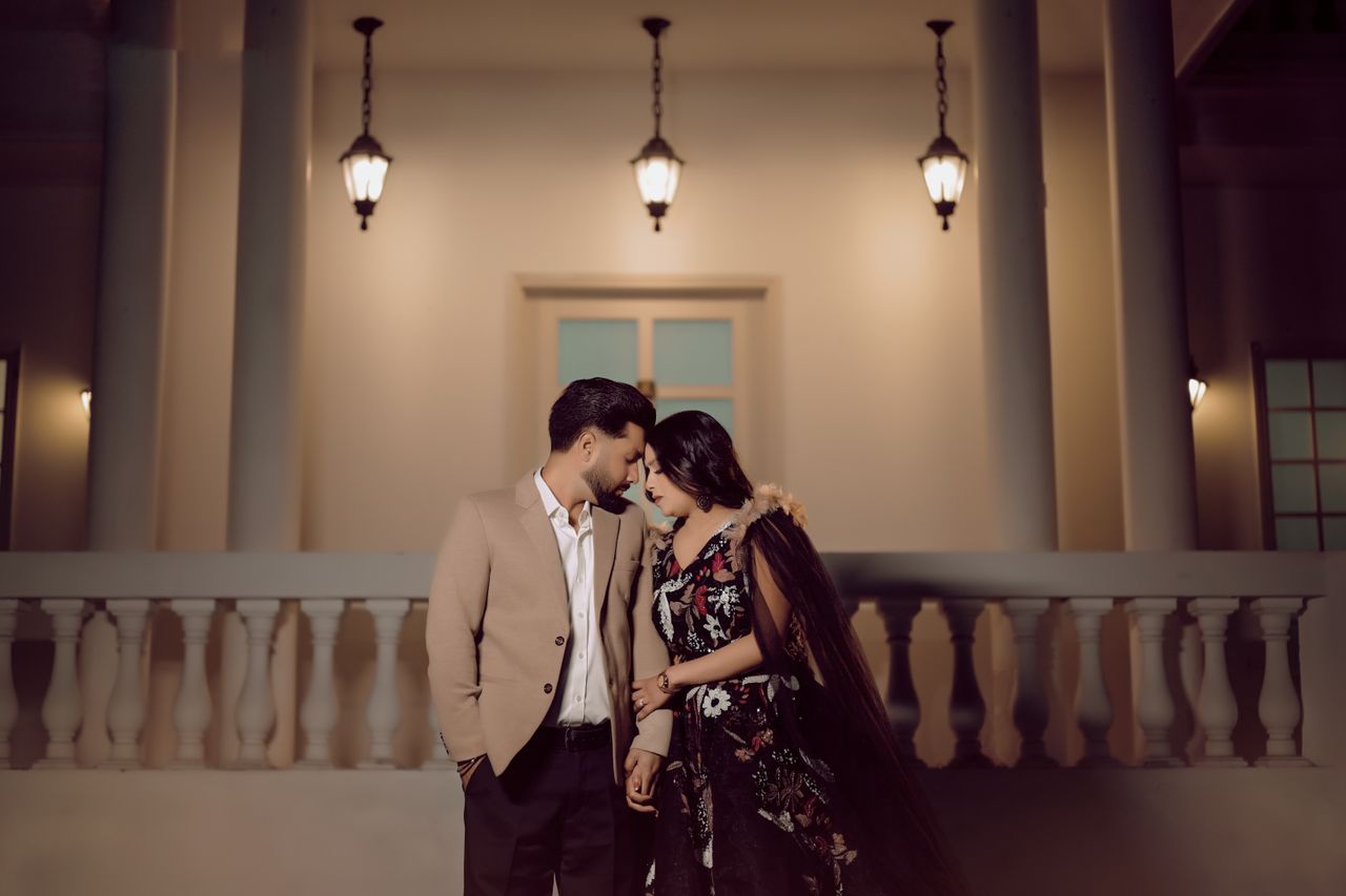 Elegant couple's portrait in Amritsar, capturing love under warm lantern light.